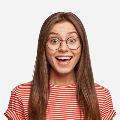 A young woman with long brown hair and round glasses, wearing a red and white striped shirt, smiles widely against a plain light background.